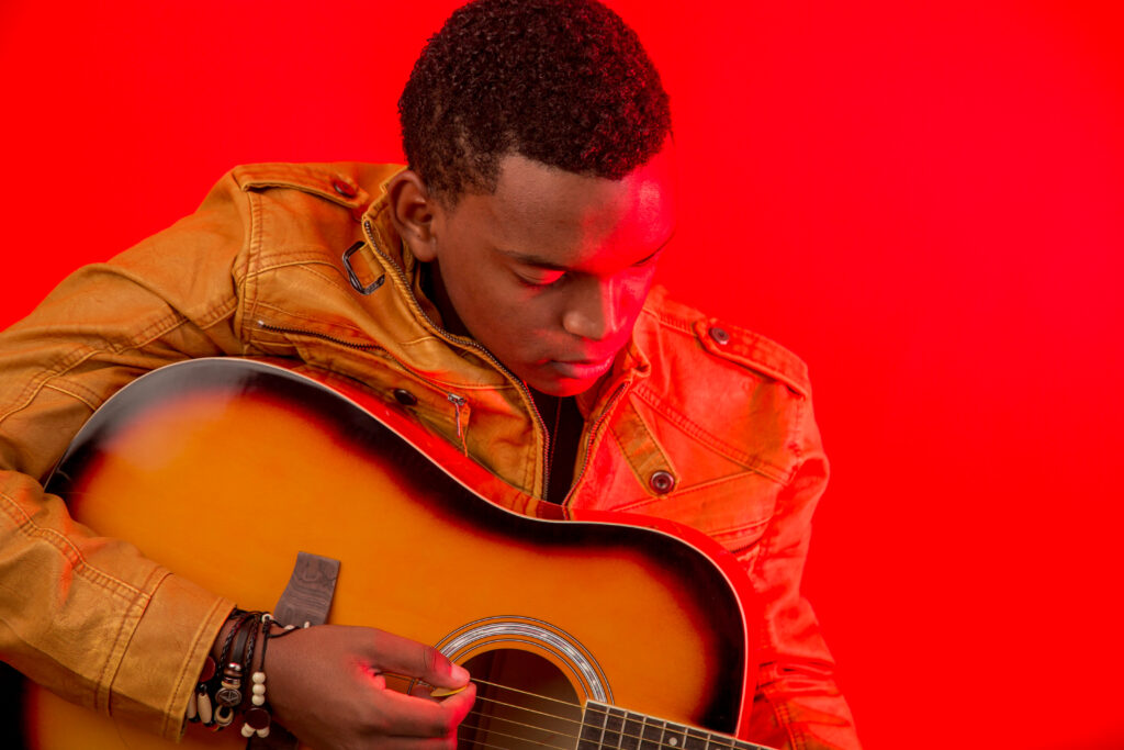 Joseph Rutakangwa playing guitar